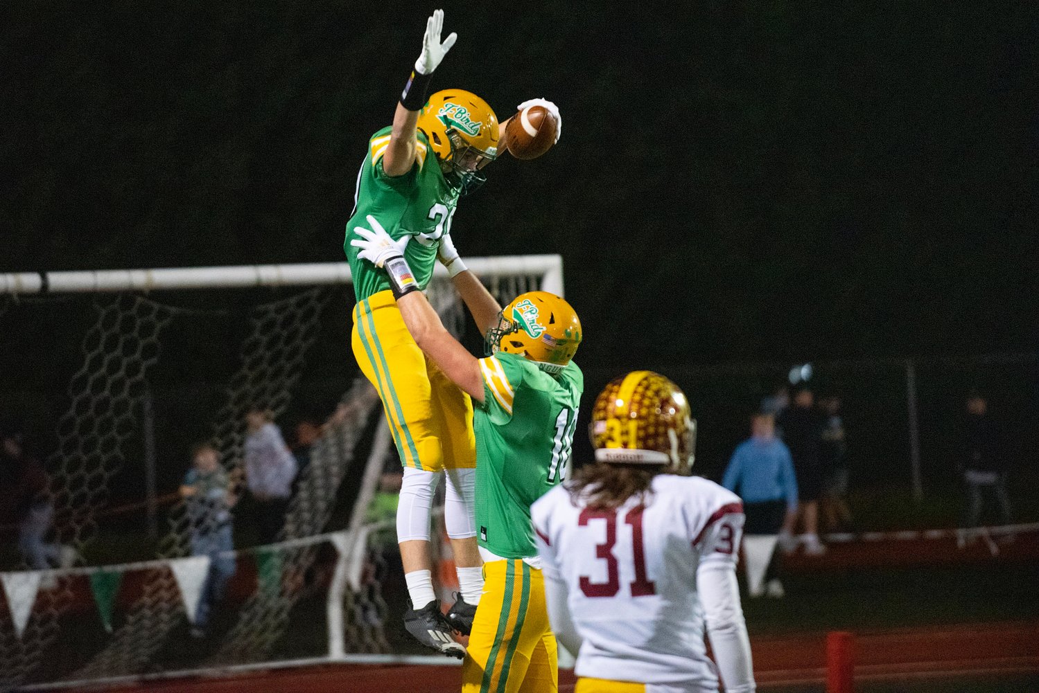 Tumwater’s Ryan Otton (10) lifts Seth Weller (20) into the air after Weller scores a receiving touchdown against Enumclaw in the 2A state quarterfinals Nov. 19 at Tumwater District Stadium.