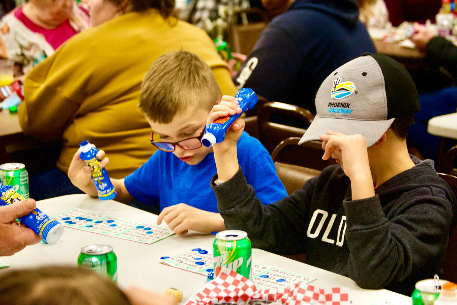 Two boys play turkey bingo Saturday night at the Chehalis Eagles event space. This is the first year guests of all ages were welcome at the Twin Cities Rotary event.