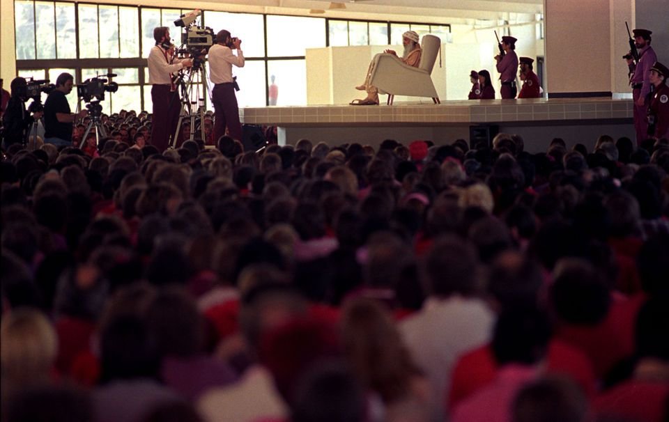 The Bhagwan Shree Rajneesh speaks to followers during a morning gathering during the summer of 1985 at Rajneeshpuram in central Oregon. Photo by Tom Treick/The Oregonian