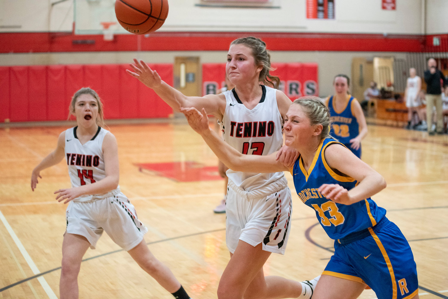 Tenino's Rilee Jones (13) and Rochester's Hannah Rodeheaver (33) battle for a loose ball on Dec. 2.