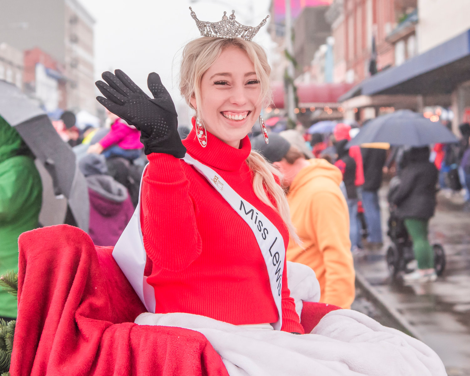 Miss Lewis County Sophie Moerke smiles and waves during the Santa Parade in downtown Chehalis on Saturday.