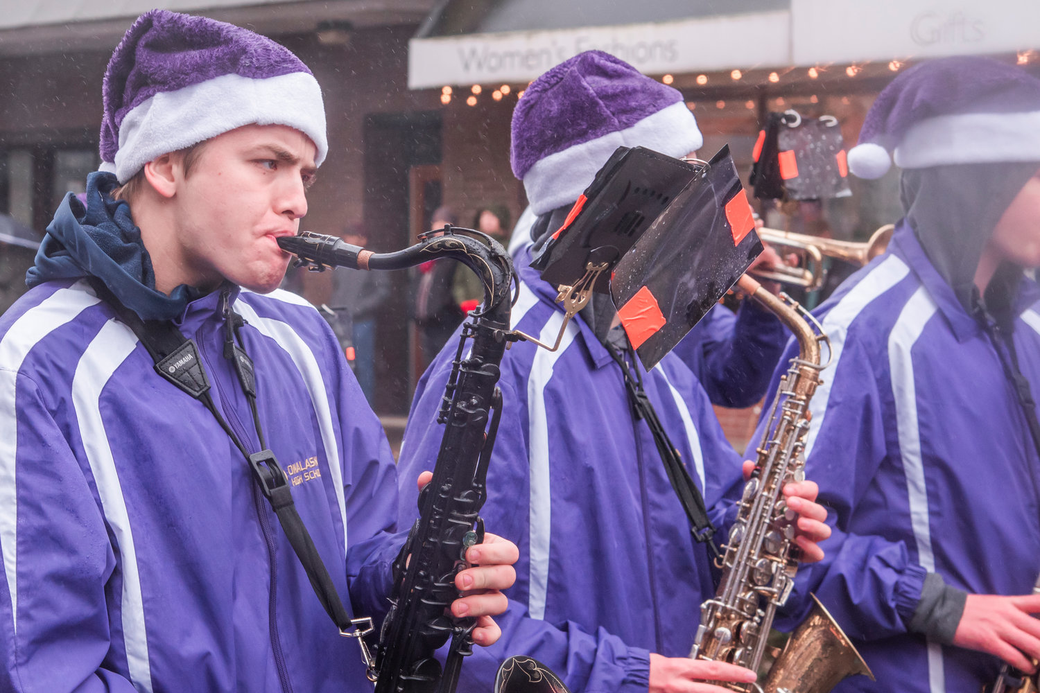 Onalaska High School band members play instruments while marching during the Santa Parade in downtown Chehalis on Saturday.