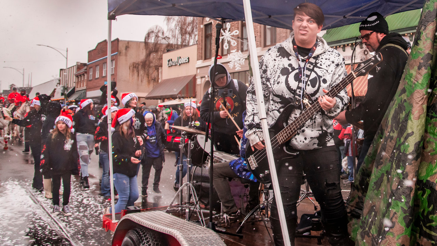 Brittany Voie plays bass guitar alongside band members while on a float during the Santa Parade in downtown Chehalis on Saturday.