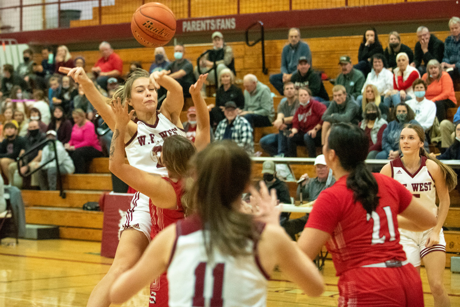 W.F. West's Kyla McCallum (25) dishes off a pass to Olivia Remund (11) against Shelton on Dec. 7.