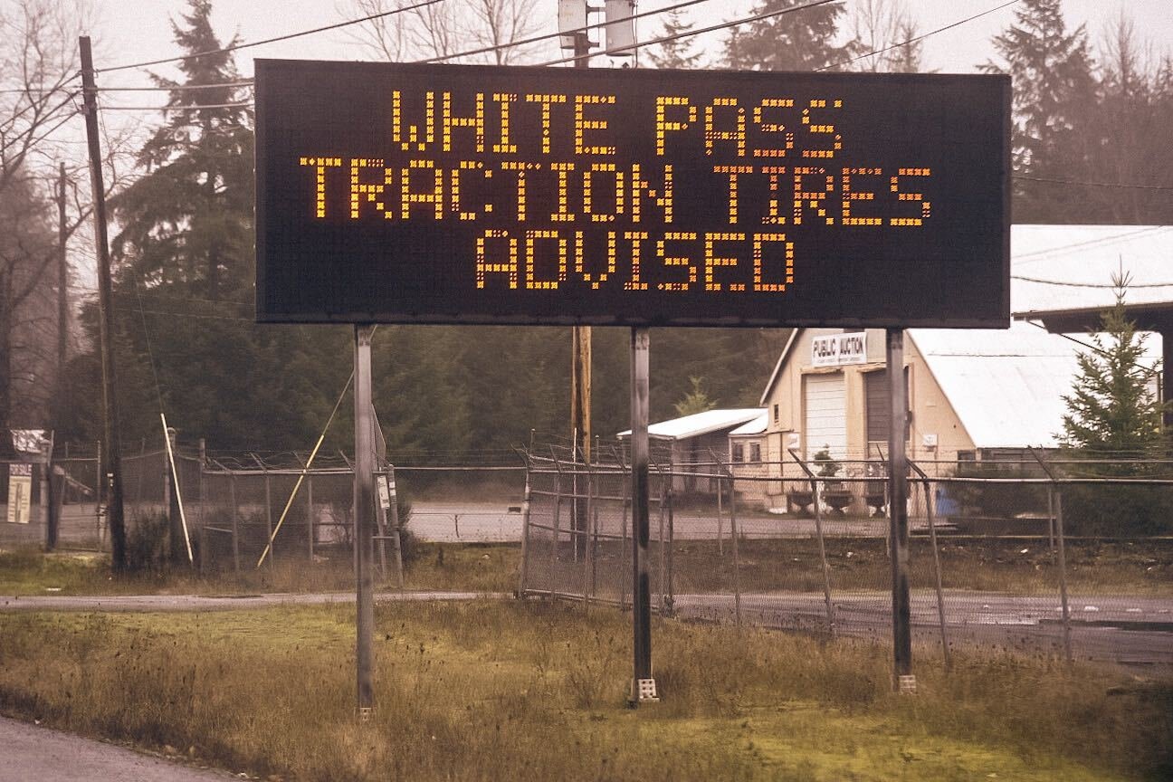 A sign reads, “White Pass Traction Tires Advised,” along Highway 12 on Monday.