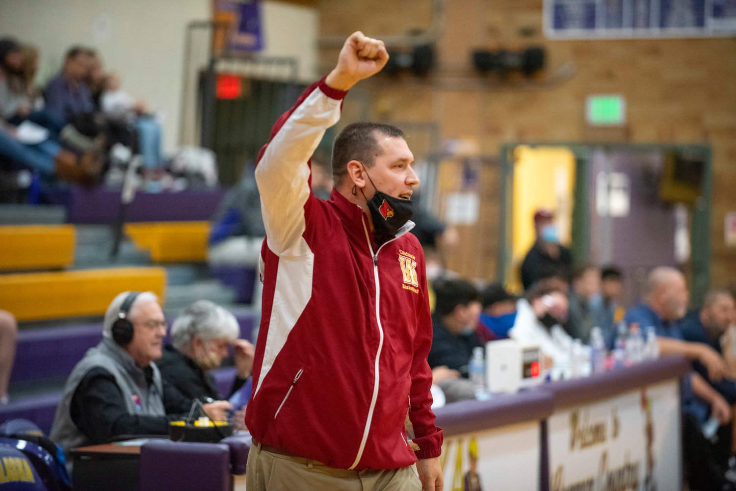 Winlock coach Nick Bamer raises his fist in celebration during a road game against Onalaska on Dec. 9.