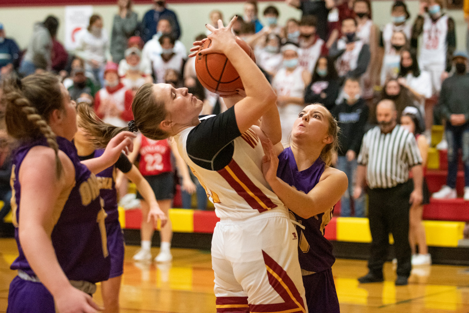 Winlock's Madison Vigre and Onalaska's Callie Lawrence battle for a rebound on Dec. 10.