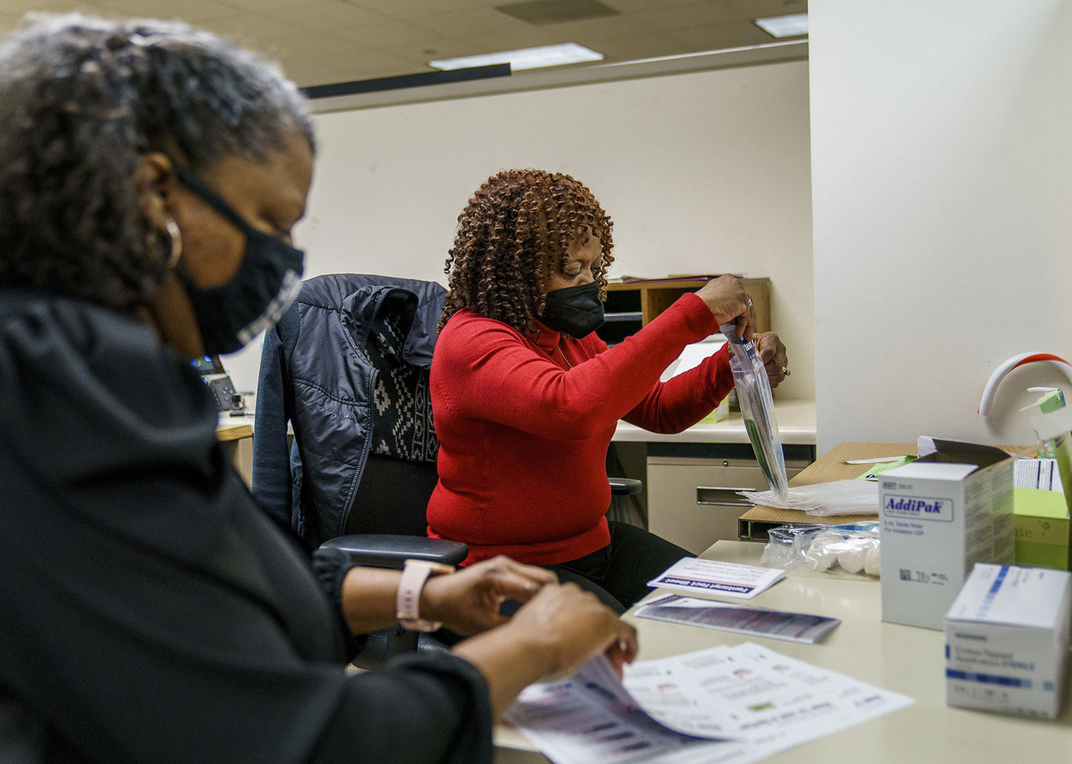 Patricia Johnson, left, and Shirley Anne Tankersley put together fentanyl testing strip packets at a Chicago Department of Public Health office Thursday, Dec. 9, 2021. The city has started passing out the kits to help stem opioid-related overdoses, the vast majority of which involve fentanyl. (Armando L. Sanchez/Chicago Tribune/TNS)