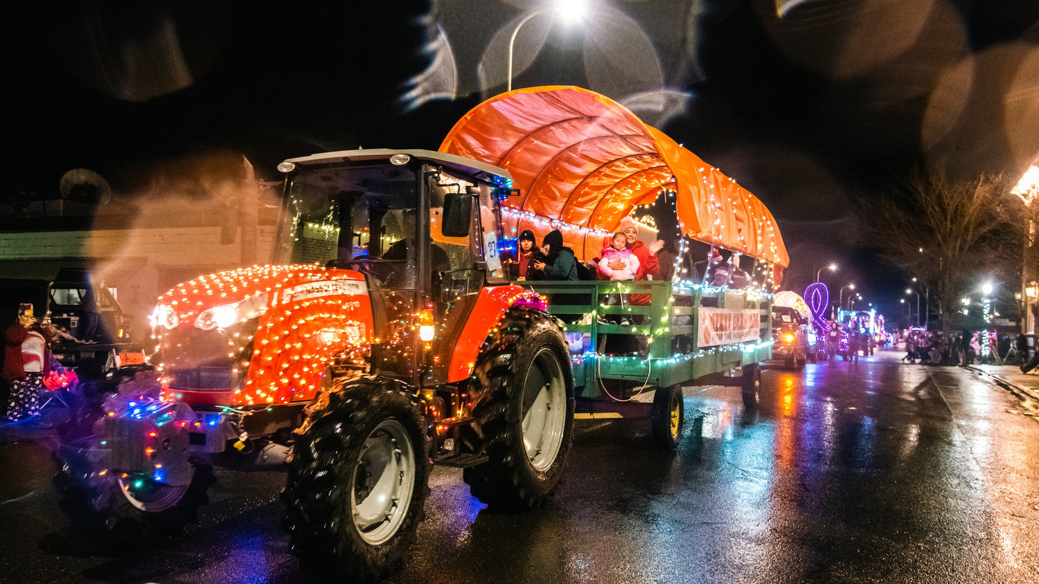 A sign reads, “Merry Christmas from the Pumpkin Patch,” on a float traveling through downtown Centralia Saturday night during the Lighted Tractor Parade.