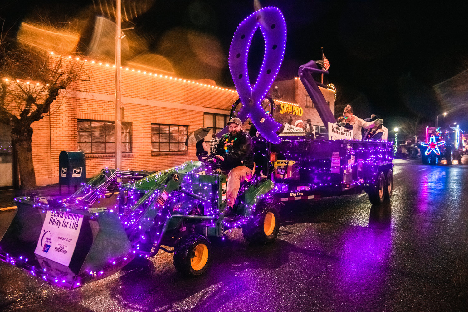 Purple lights illuminate the Lewis County Relay for Life float during the Lighted Tractor Parade in Centralia Saturday night.