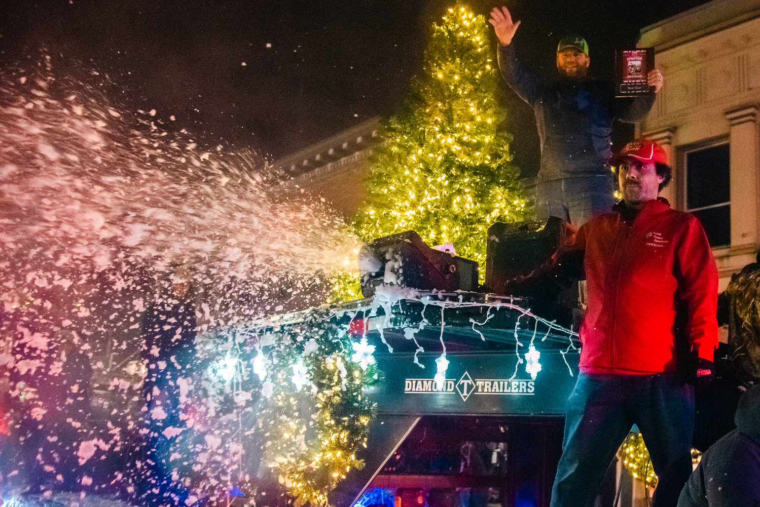 A snow machine blasts into the air from a float during the Lighted Tractor Parade in Centralia Saturday night.