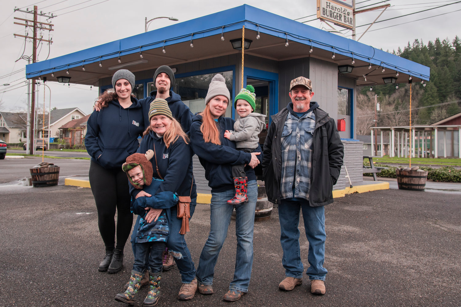 From left, Brenna Kinsey and Kyle Dyer, Lottie Dyer, with Aryelle Newton and her kids, and Michael Dyer smile and pose for a photo outside Harold’s Burger Bar located at 727 South Gold Street in Centralia.