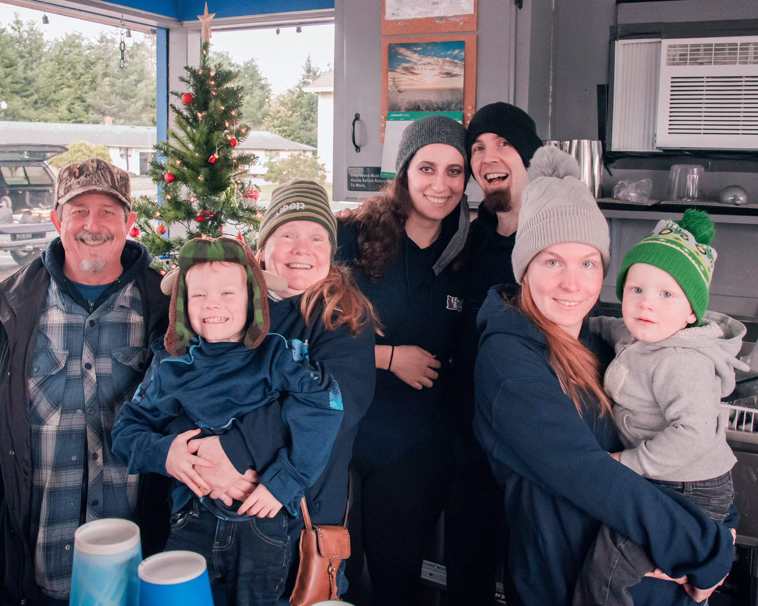 From left, Michael and Lottie Dyer, Brenna Kinsey and Kyle Dyer, with Aryelle Newton and kids, smile and pose for a photo inside Harold’s Burger Bar located at 727 South Gold Street in Centralia.