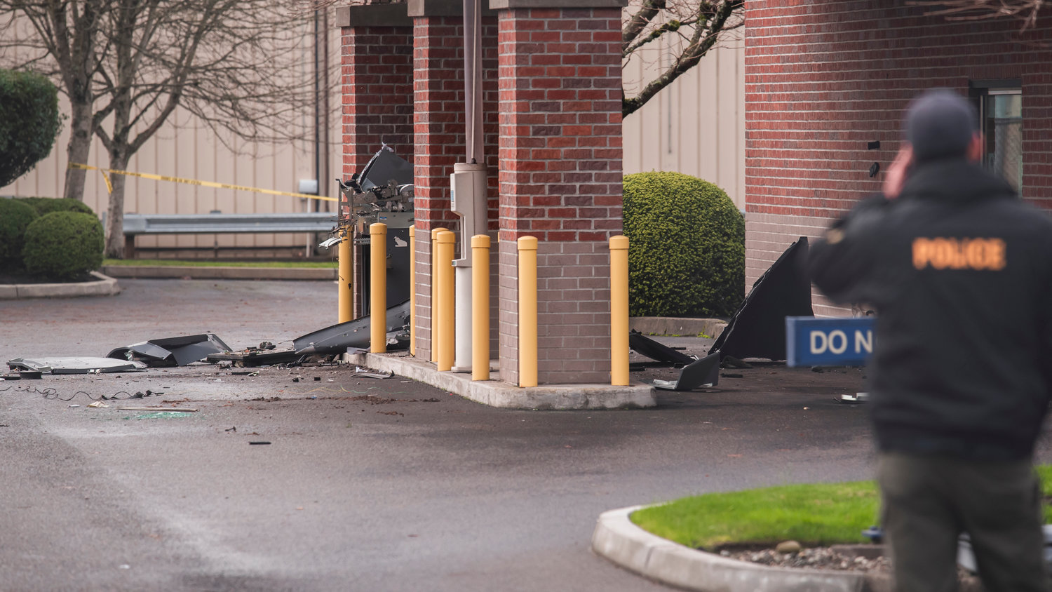 Debris are seen scattered in an area where an ATM once stood outside the 1st Security Bank in Centralia Sunday morning after reports of an explosion in the area.