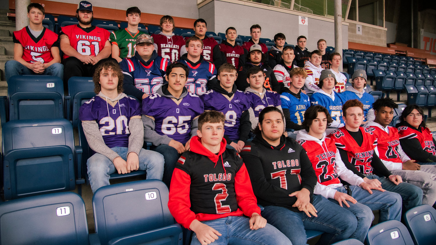 Athletes selected for the All-Area Football team pose for a photo at Tiger Stadium in Centralia sporting their school’s football jerseys.