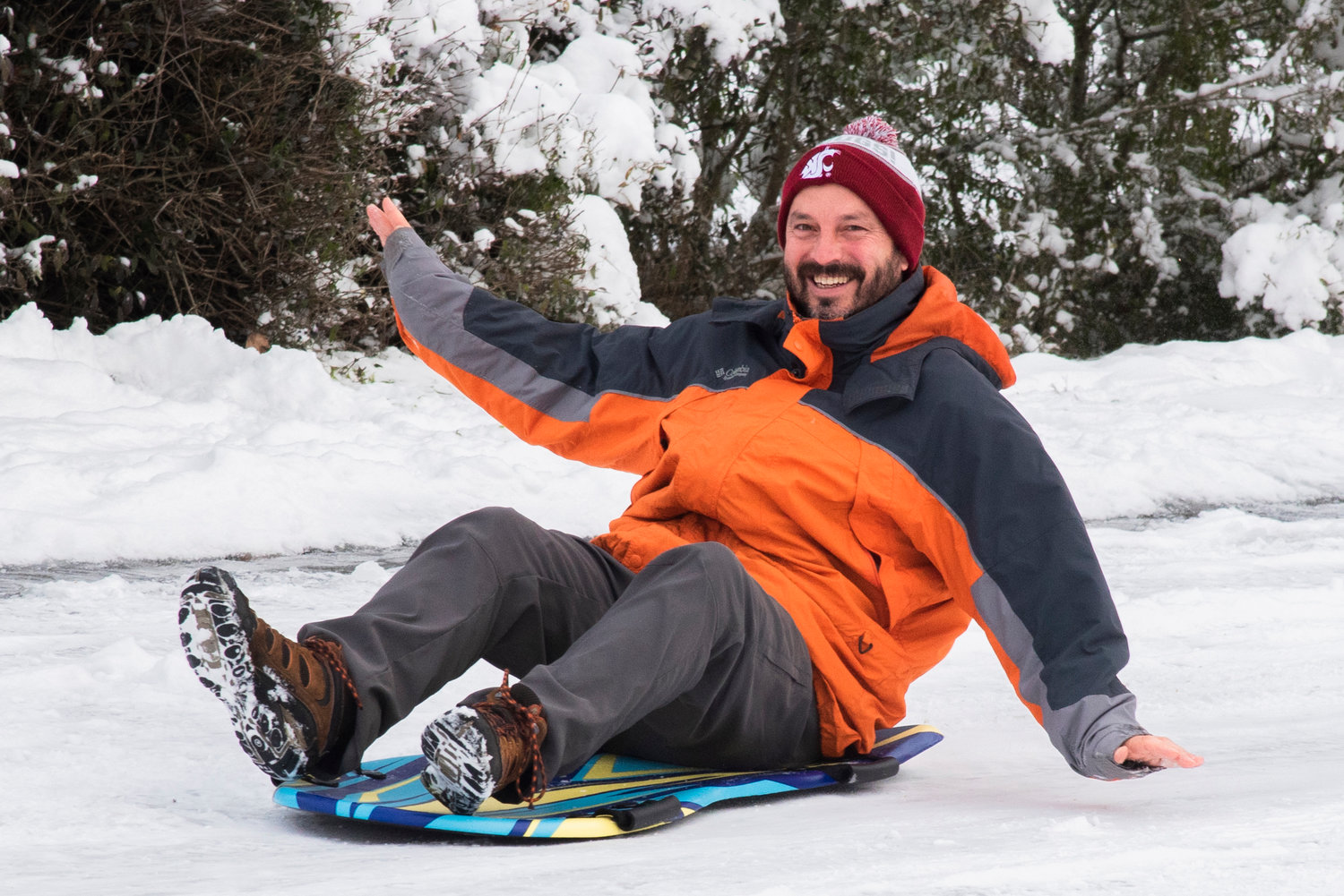 Centralia High School Assistant Principal Mike Stratton smiles as he sleds down East Locust Street Monday morning.