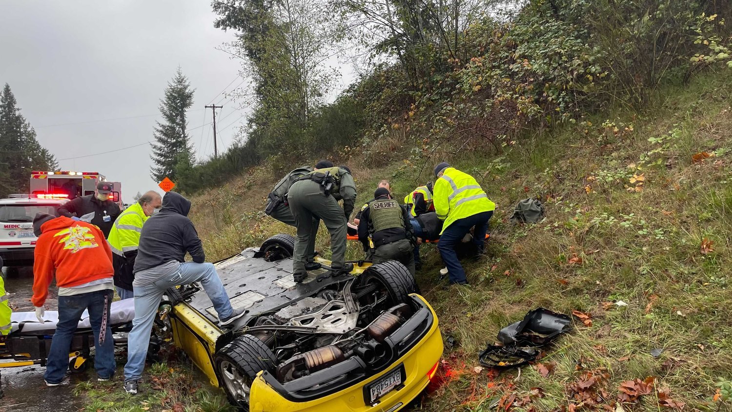 Emergency responders and passersby assist at the scene of a crash on U.S. Highway 12 near Salkum in November. Sheriff Rob Snaza and Lewis County Commissioner Sean Swope were among those to help after the crash, which was not fatal.