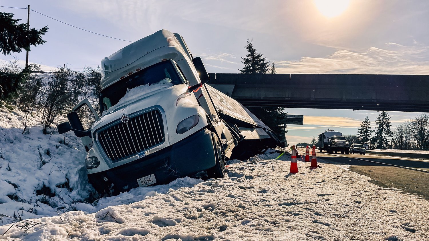 A semi-truck is seen tipped off the roadway along the northbound lane of Interstate 5 near the Koontz Road overpass in this file photo from last month's winter weather.
