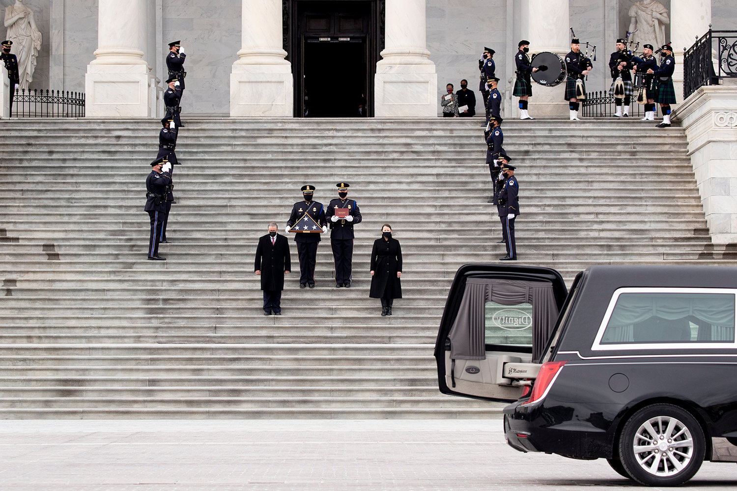 The remains of Capitol Police Officer Brian Sicknick are carried down the East Front steps after lying in honor in the Rotunda of the U.S. Capitol on Feb. 3, 2021, in Washington, DC. Officer Sicknick died as a result of injuries he sustained during the Jan. 6 attack on the U.S. Capitol. (Michael Reynolds/Pool/Getty Images/TNS)
