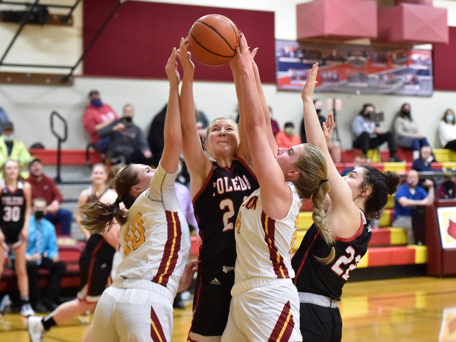Toledo’s Greenlee Clark (24) is surrounded by multiple players while attempting to grab a rebound against Winlock on Wednesday, Jan. 5, in Winlock.