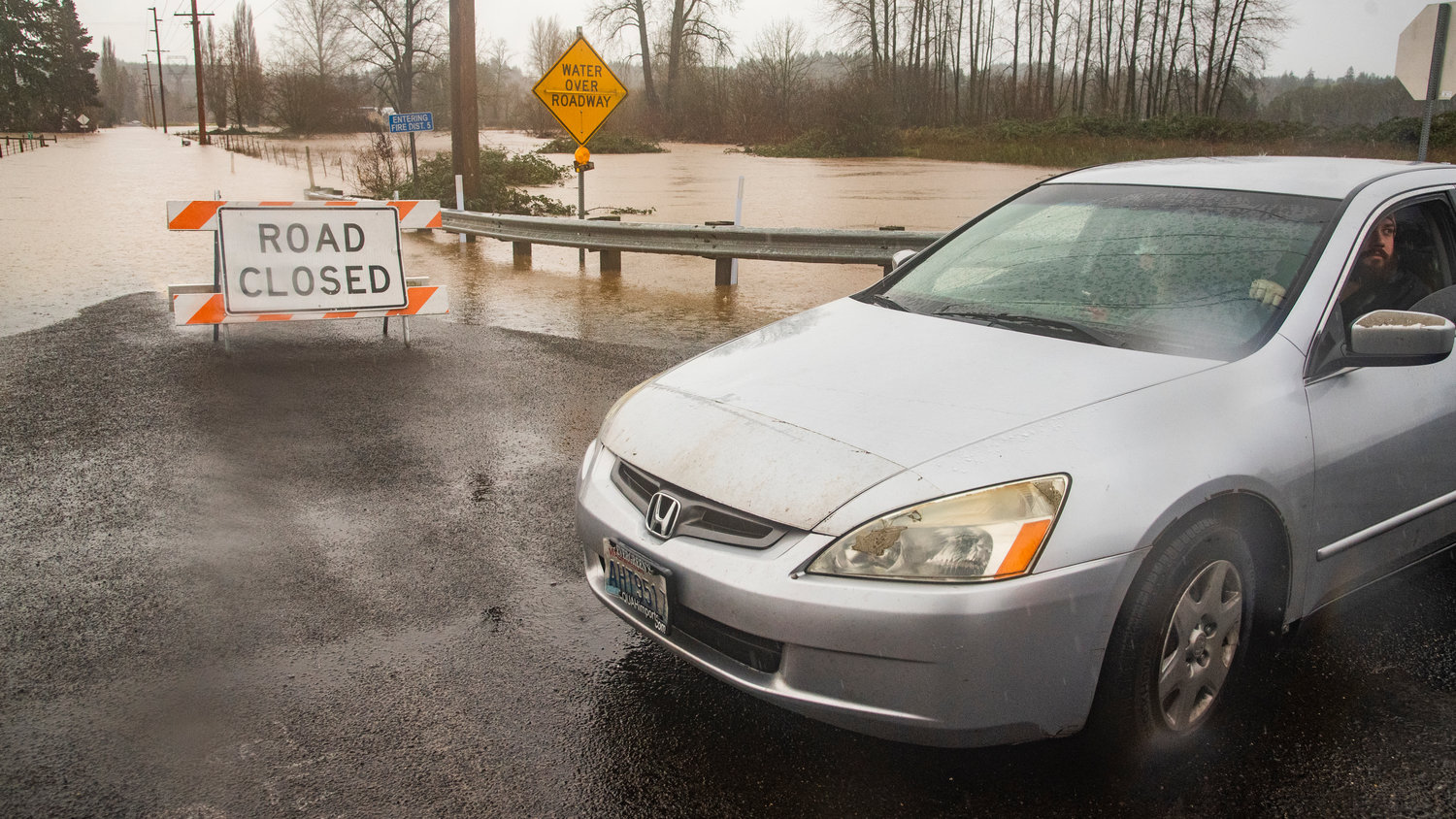 Signs block Hamilton Road in Chehalis as water levels continue to rise and flood roadways across Lewis County.