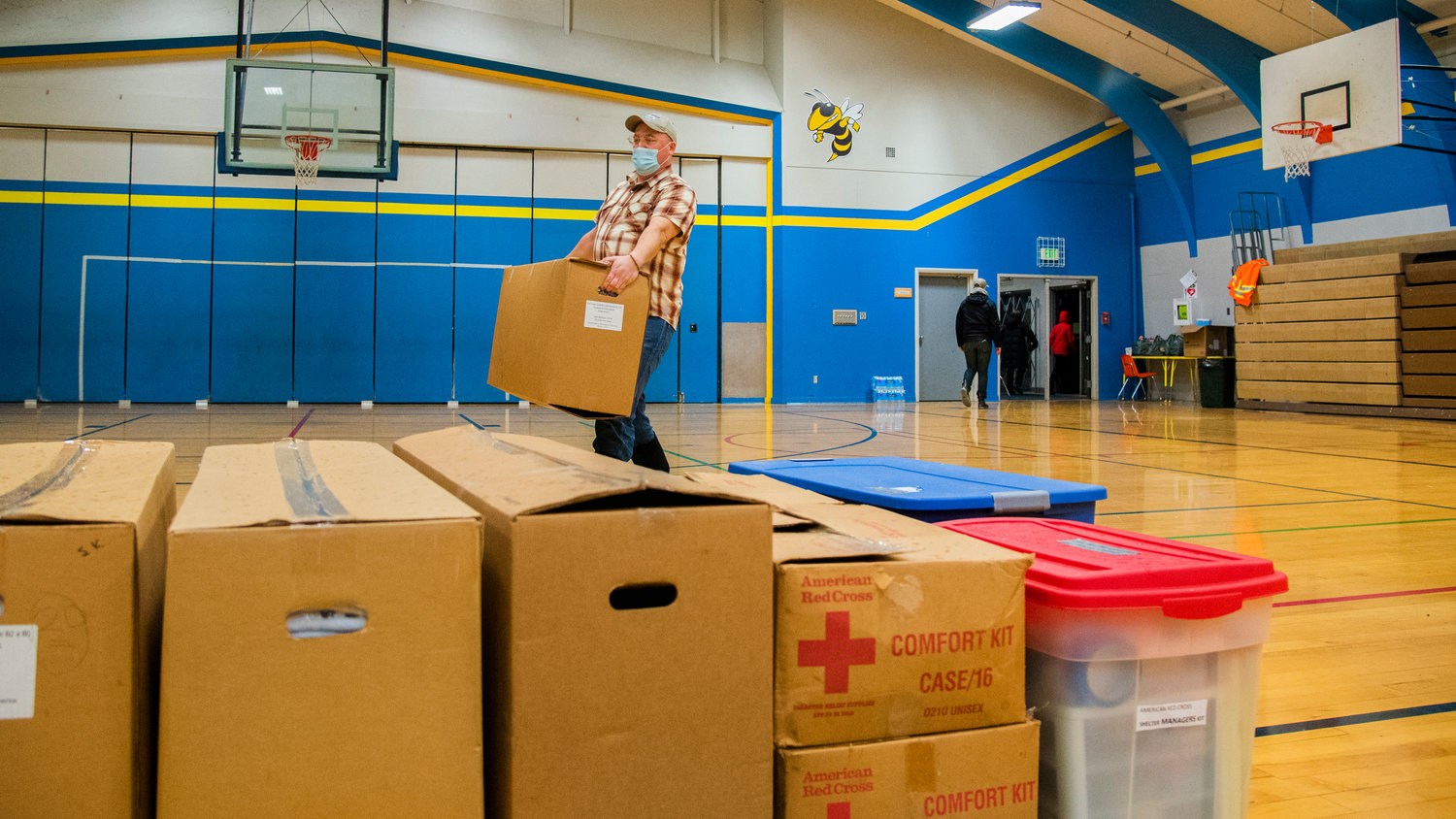 Public Health Director J.P. Anderson carries American Red Cross supplies into Centralia Middle School Thursday evening.