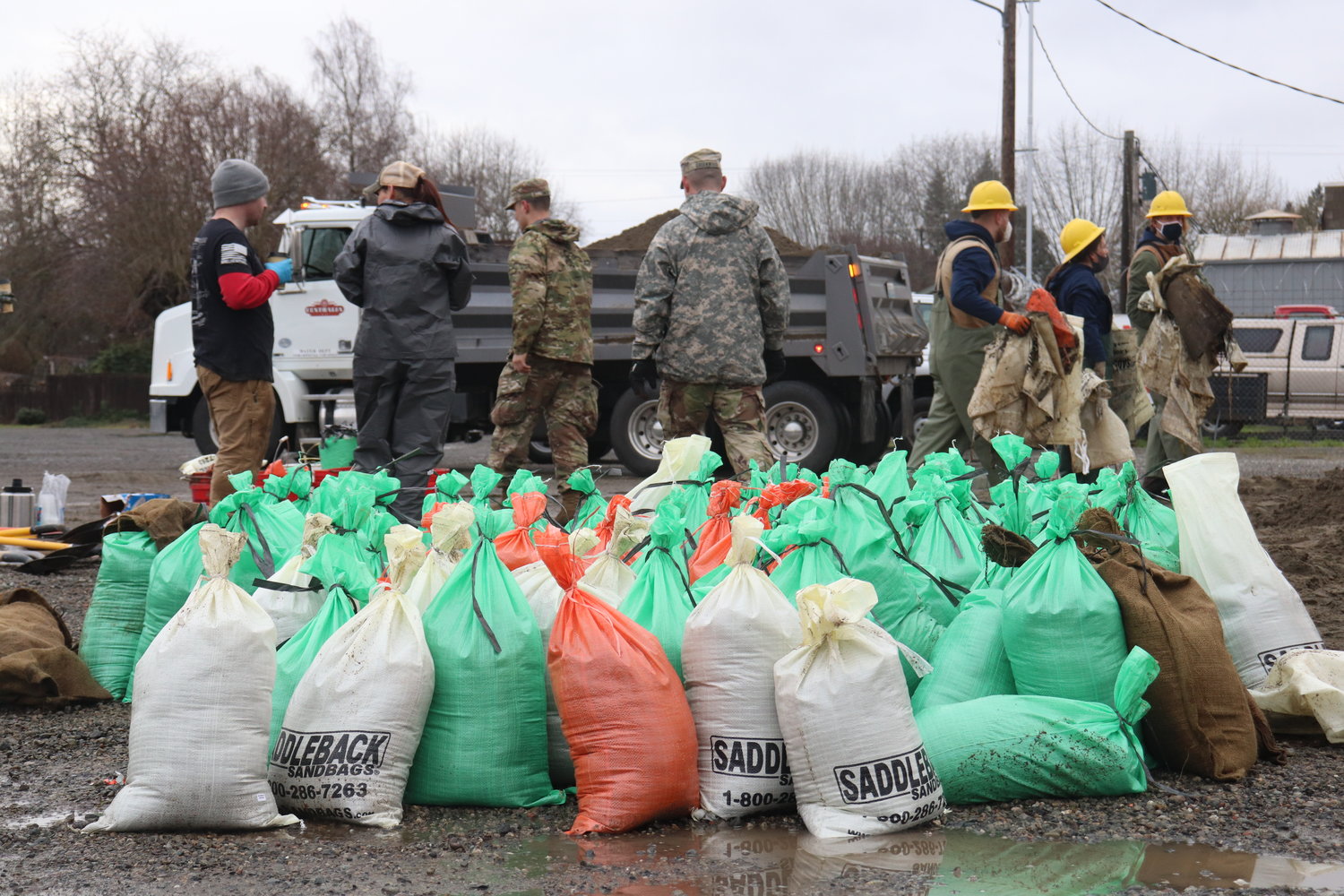 Members of the Washington National Guard help fill sandbags at the Centralia sandbag station Friday afternoon.