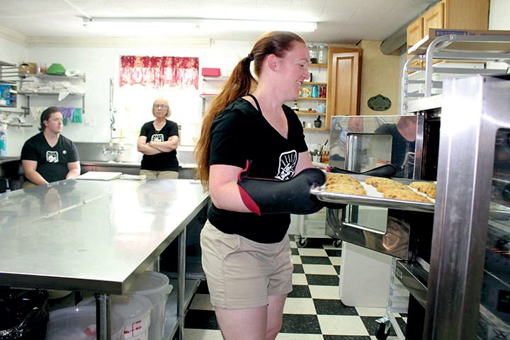 Owner Callie Carpenter puts cookies in an oven in this Chronicle file photo.