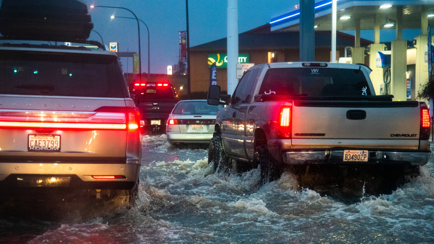 Water splashes as vehicles drive along Harrison Avenue in Centralia Friday morning.