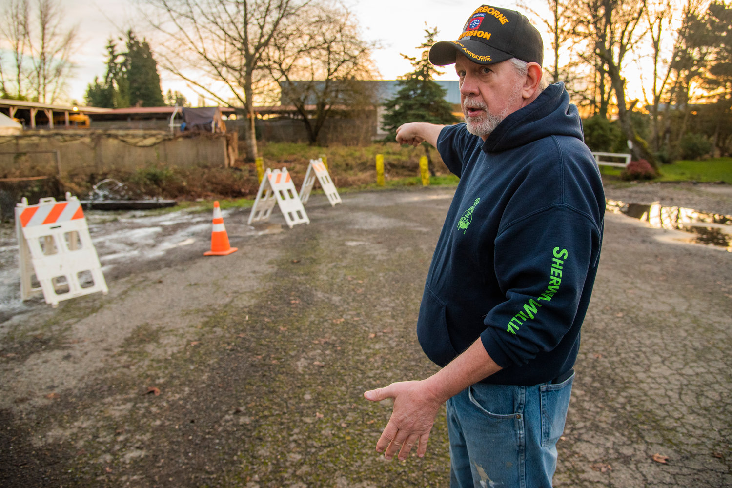 James Miller, 64, points to where China Creek flowed over a manhole in the 500 block of Hemlock Street in Centralia.