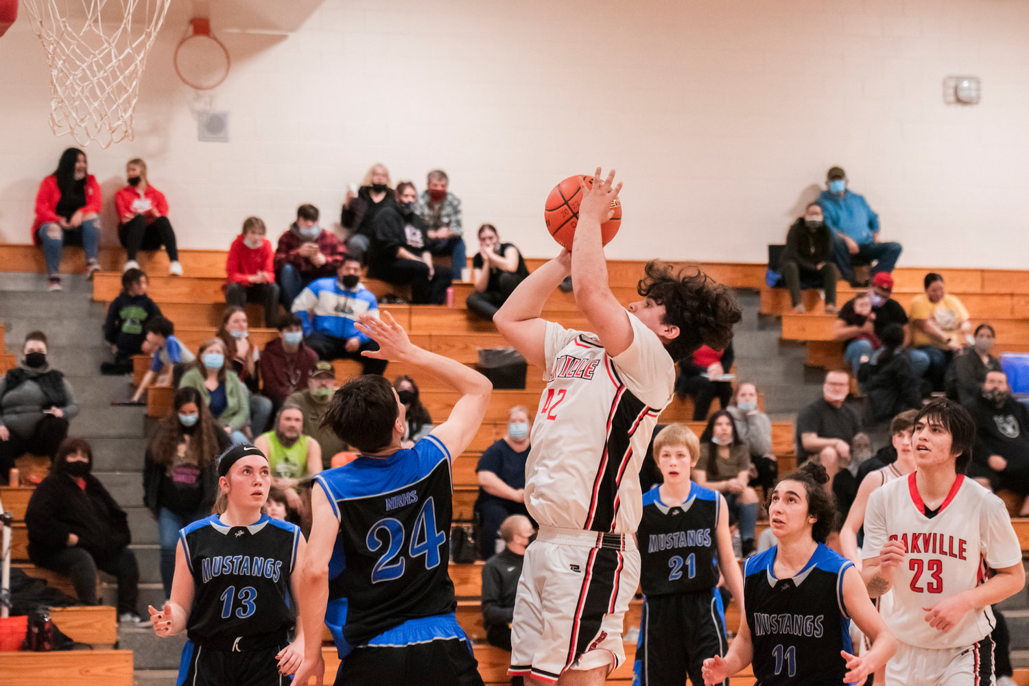 Oakville’s Jeremy Wilbur (42) looks to shoot over North River defenders Tuesday night.