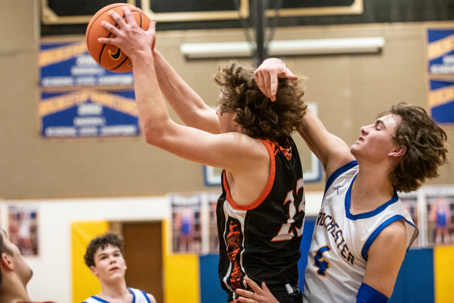Centralia's Cole Wasson (23) hauls in a rebound over Rochester's Saywer Robbins (4) on Jan. 19.