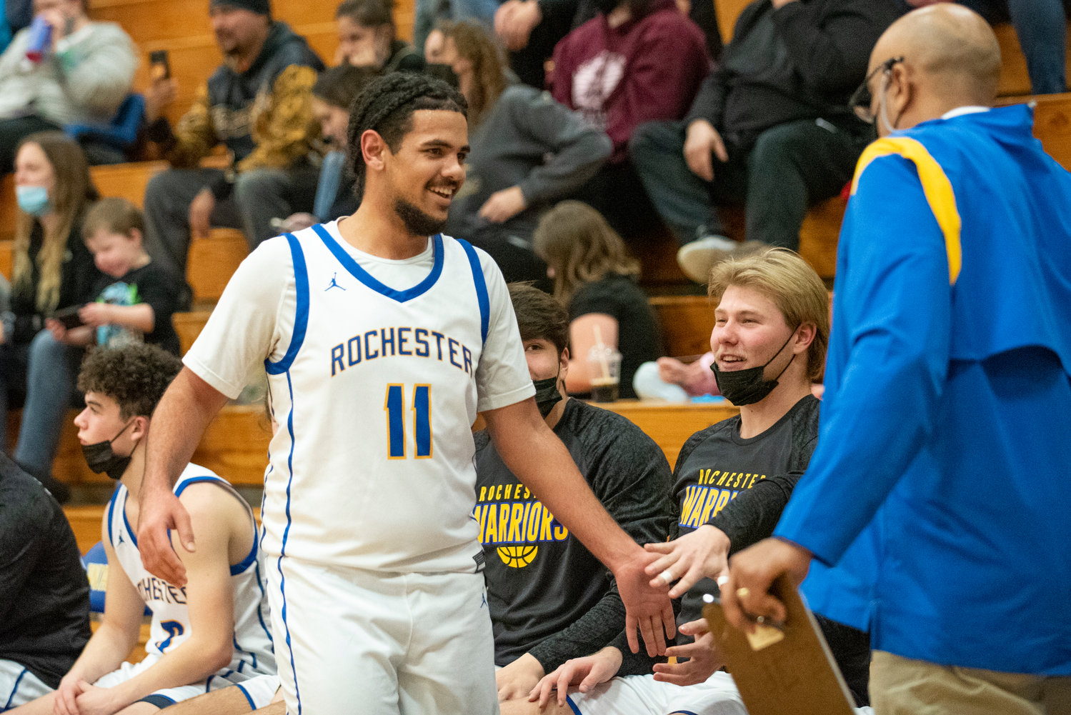 Rochester's Cam'Ron Henderson (11) high-fives teammates during a home game on Jan. 19.