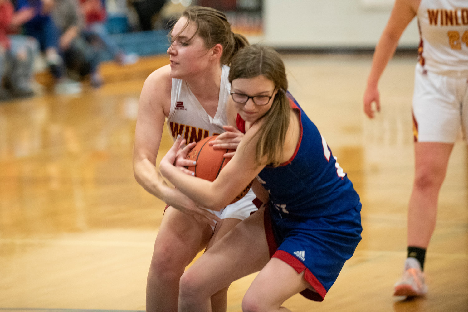 Winlock's Madison Vigre fights for a loose ball with a Willapa Valley player on Jan. 21.