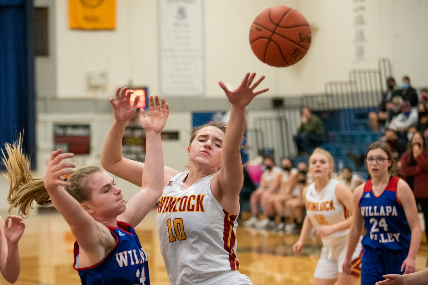 Winlock's Madison Vigre (10) reaches for a loose ball against Willapa Valley on Jan. 21.