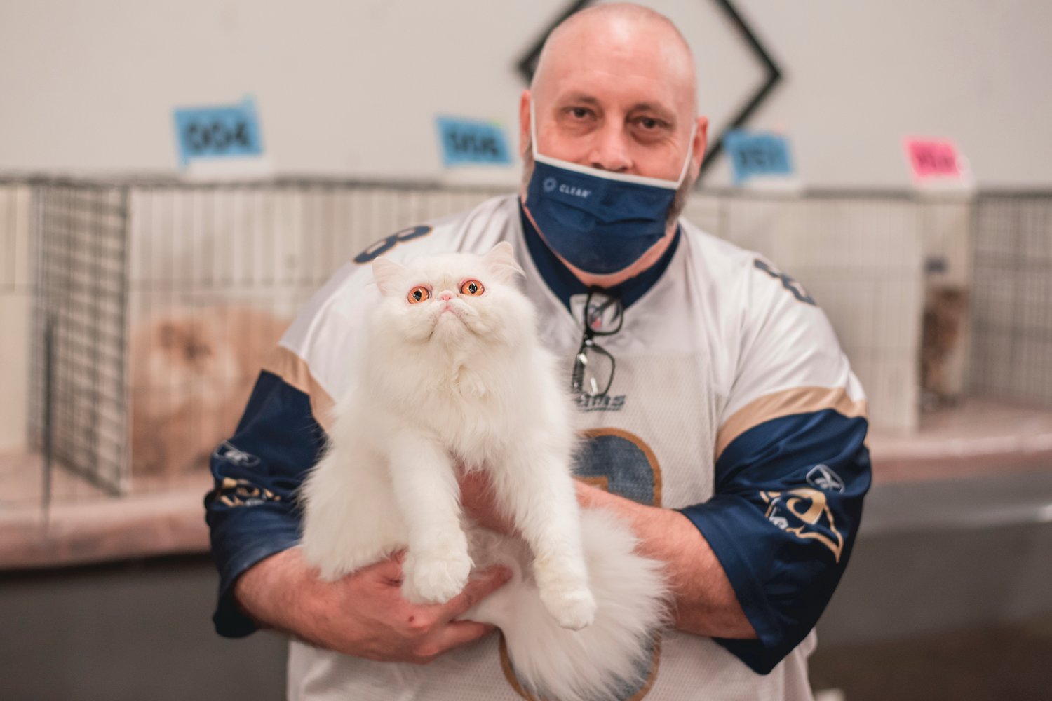 Mike Pfister carries Brienne of Tarth through the Blue Pavilion at the Southwest Washington Fairgrounds during a cat show in Centralia on Sunday.