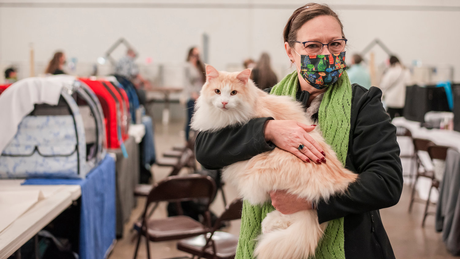 Esther Edgren carries Medford through the Blue Pavilion at the Southwest Washington Fairgrounds in Chehalis on Sunday during Medford’s last cat show before retirement.