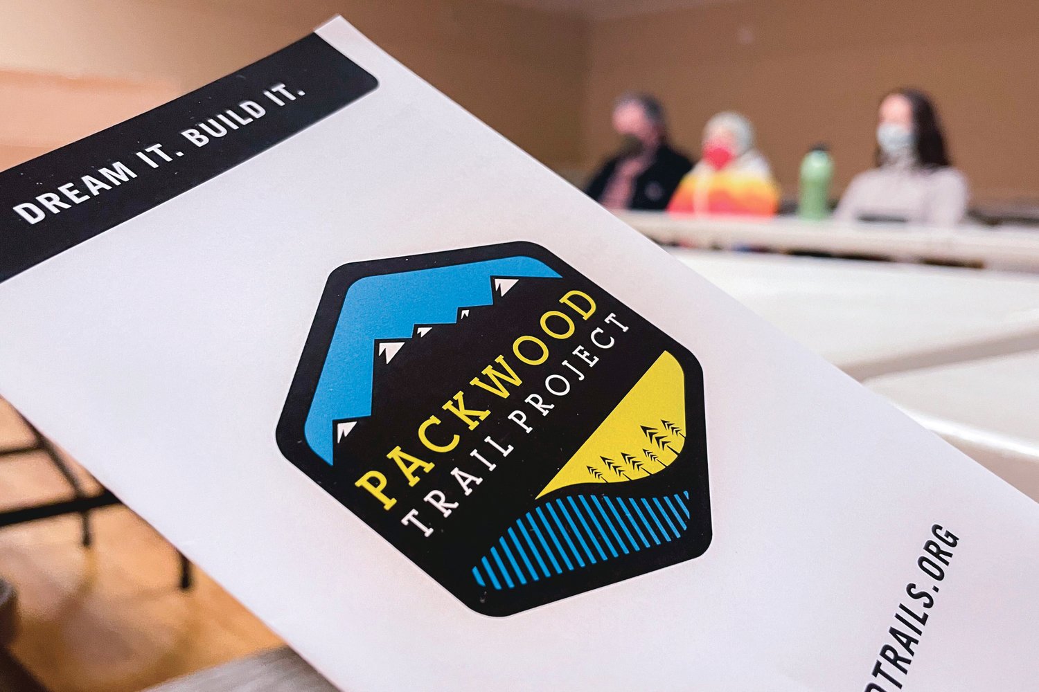 A pamphlet for the Packwood Trail Project is passed around during a public meeting at the Packwood Community Center on Saturday.