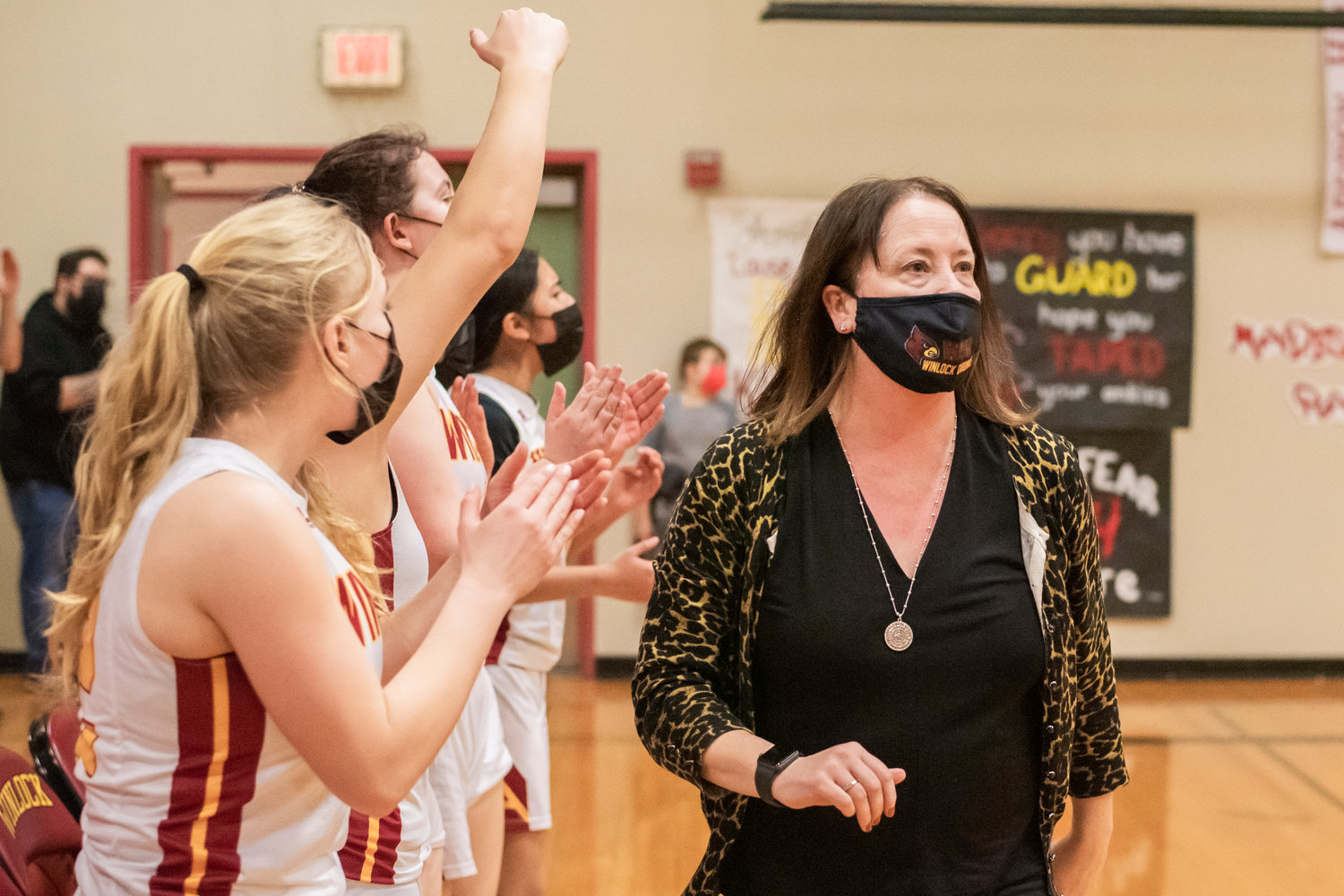 Winlock Head Coach Dracy McCoy looks on as athletes celebrate during a game against Rainier Wednesday night.