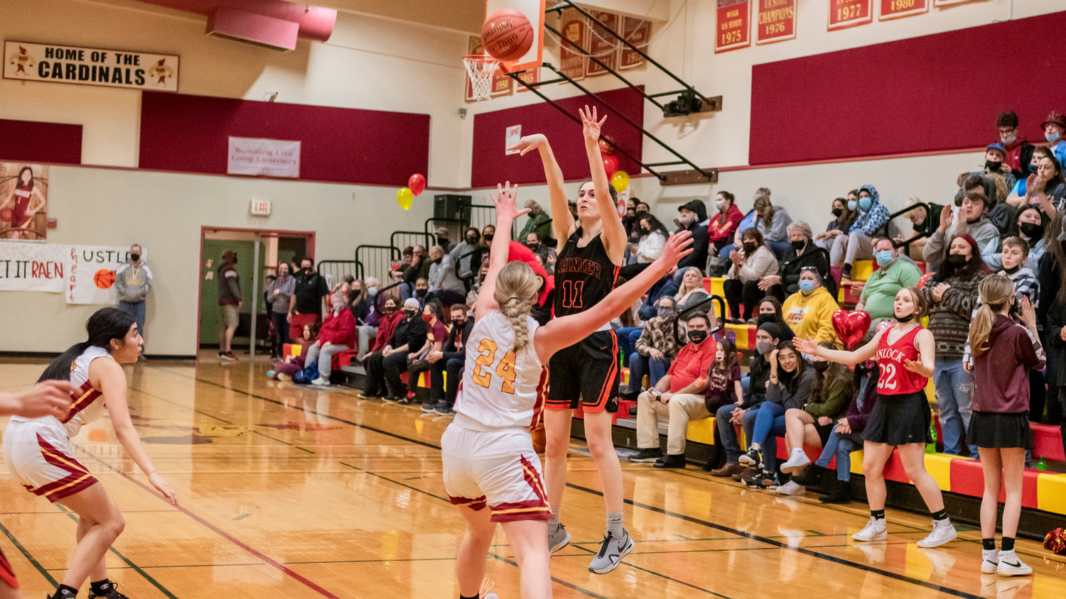 Rainier’s Faith Boesch (11) puts up a three-point shot during a game in Winlock Wednesday night.