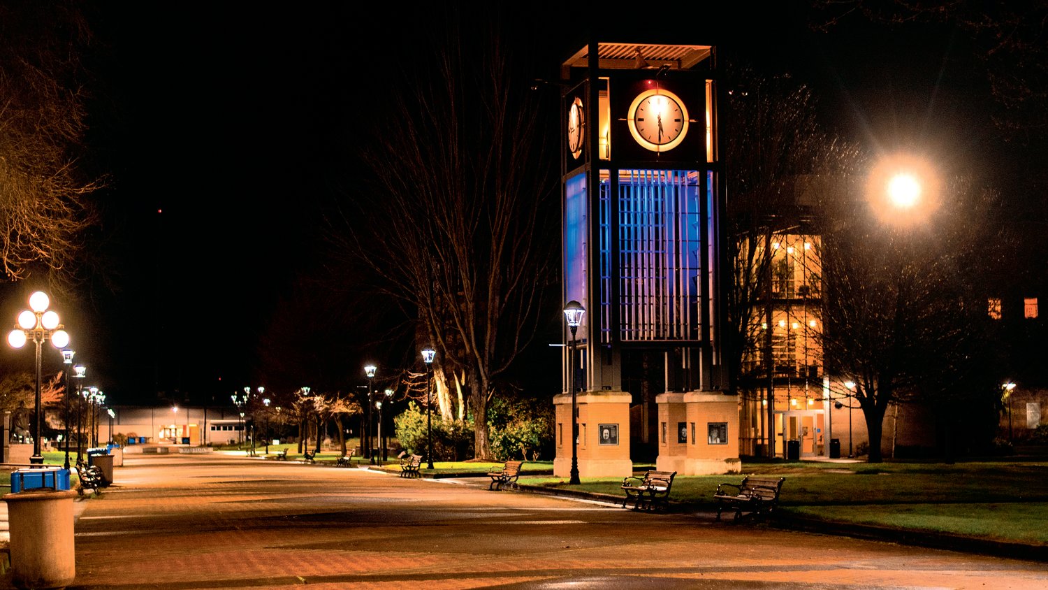 The Centralia College clock tower is illuminated in blue and yellow Thursday night as bells ring throughout campus.