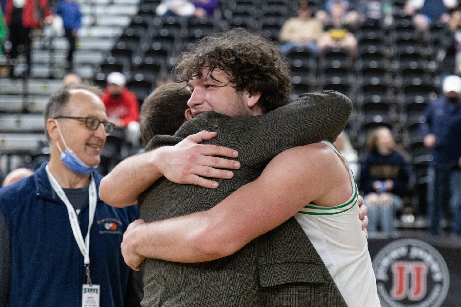 Tumwater forward Ryan Otton hugs coach Josh Wilson after the T-Birds beat Port Angeles to finish fourth at state, their highest finish at state since 1976.