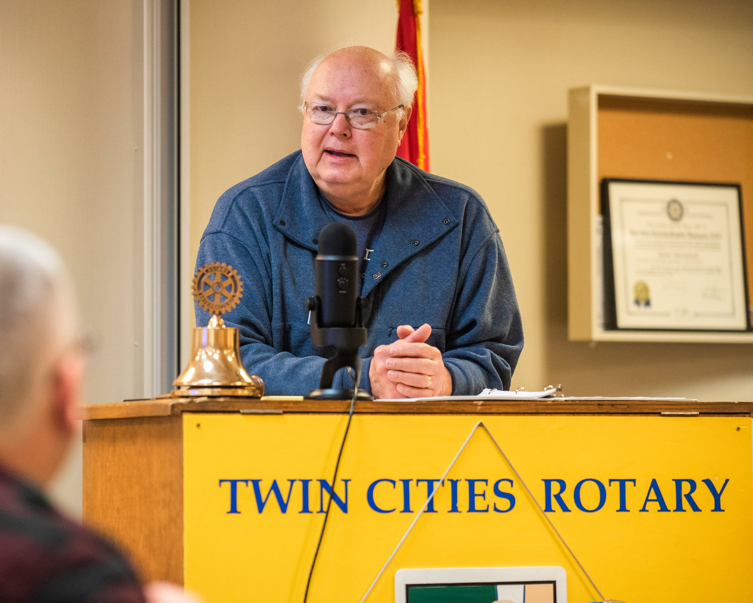 Larry McGee, a Twin Cities Rotary Club member, speaks at a Friday morning club meeting about a recent Zoom call with Polish Rotarians 30 kilometers from the Ukrainian border.