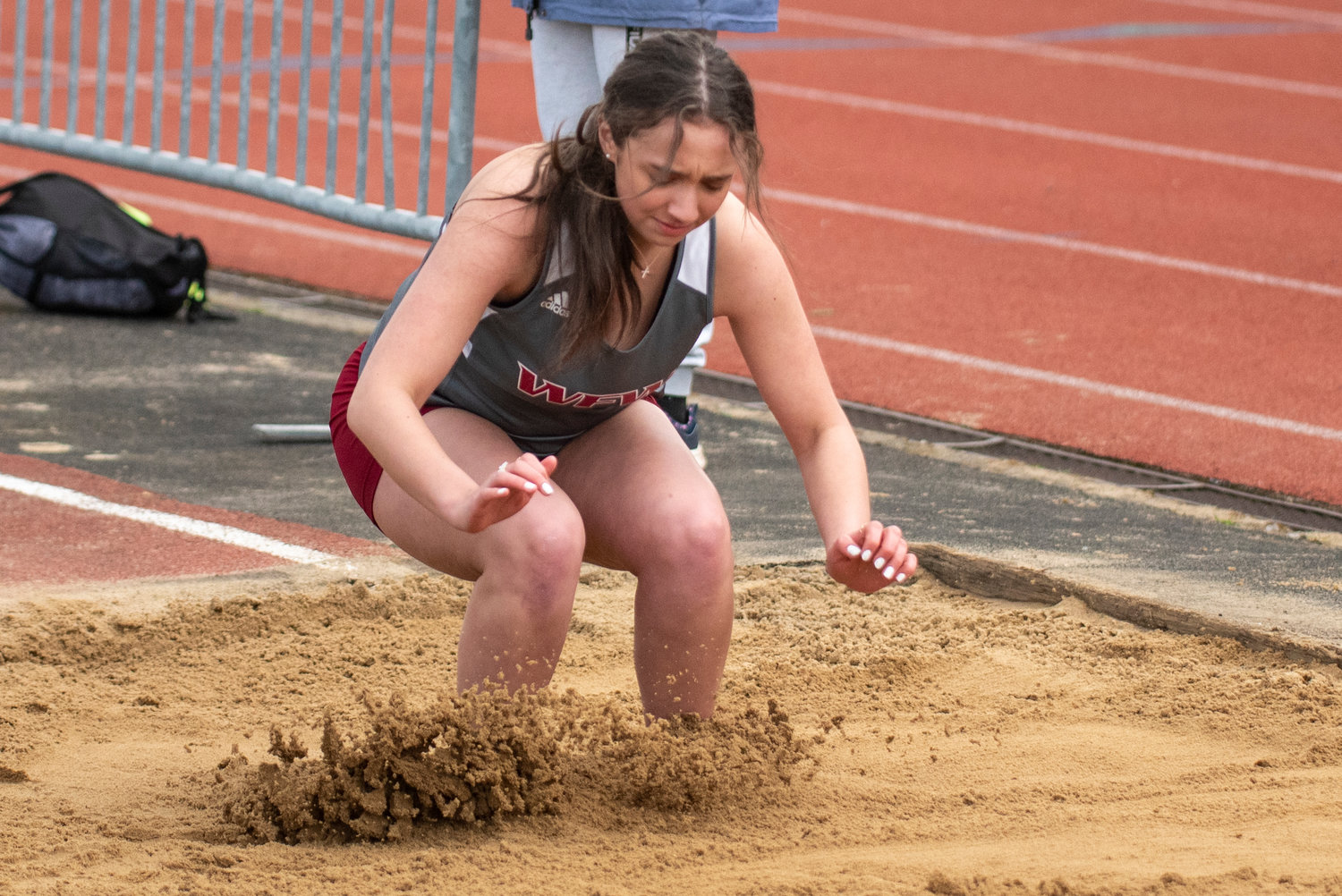 A W.F. West long jumper hits the sand pit during a home meet against Shelton on March 16.