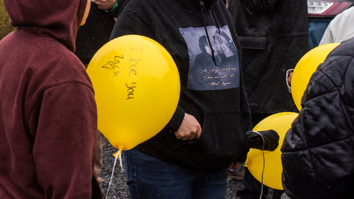 Messages are written on balloons before they are released during an event in remembrance of Zachary Rager Wednesday afternoon.