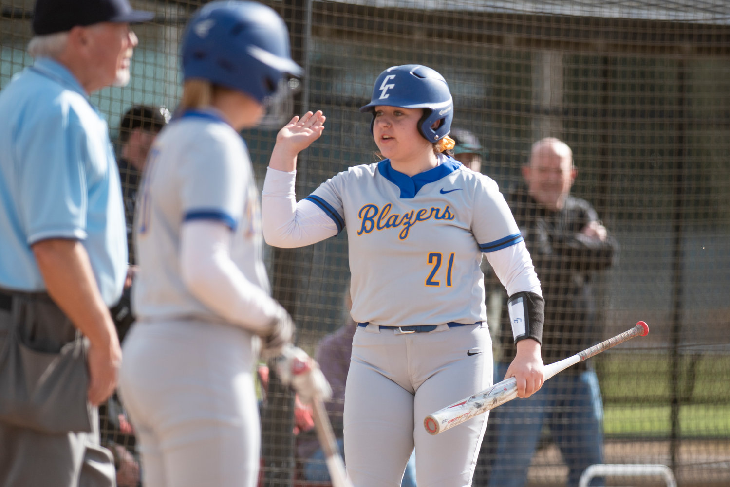 Centralia College's Kaylee Ashley (21) high-fives Kylie Baker after Baker scores a run against Chemeketa at home on March 25.