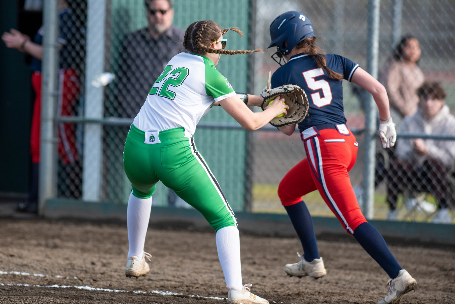 Tumwater first baseman Megan Paull (22) attempts to tag out Black Hills' Alexa Robles (5) during a game at Tumwater High School on March 25.