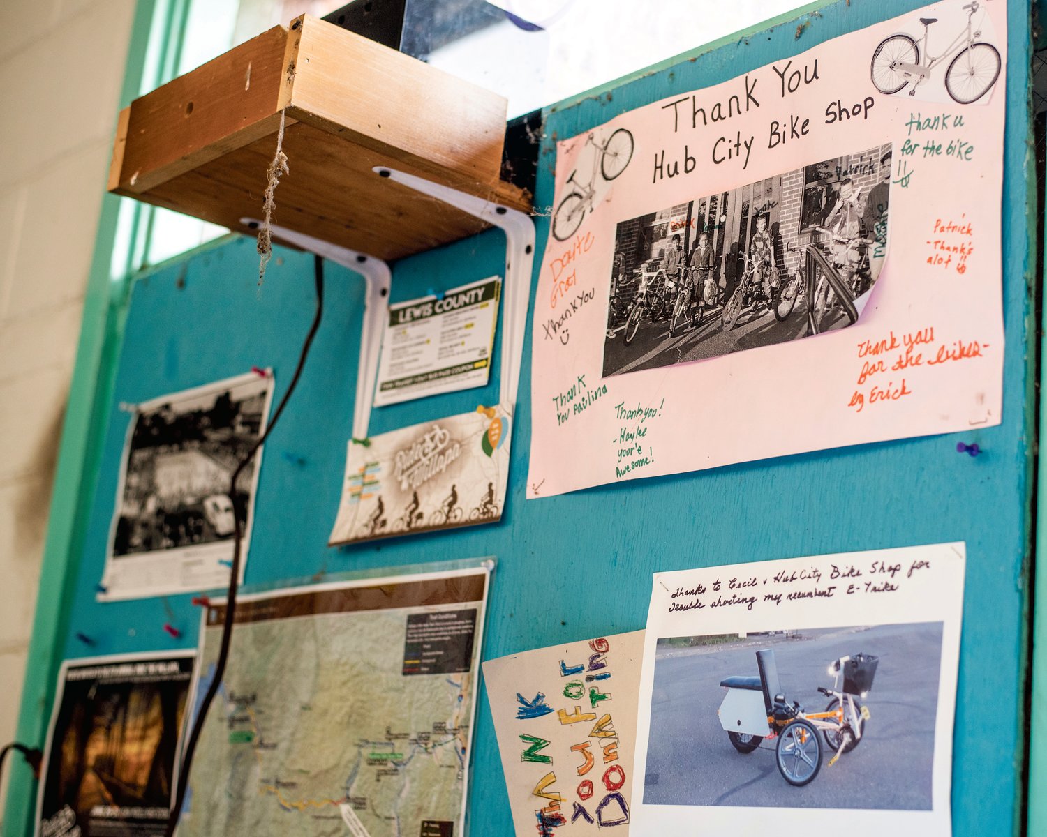 Photos and thank you cards hang on display inside the Hub City Bike Shop in Centralia.