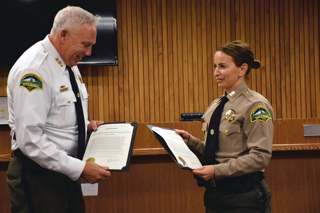FILE PHOTO — Thurston County Sheriff John Snaza presents a lifesaving award to Thurston County Deputy Andrea Moore, of Yelm, on Friday, Sept. 17, at the Thurston County Courthouse. She was stabbed by Ronald Clayton in Yelm while responding to a call.