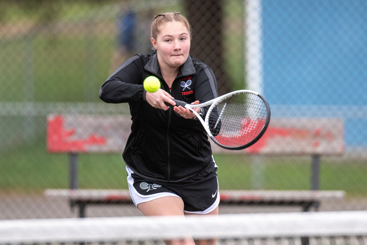 Tenino's Bailey McKitrick returns a hit from an Eatonville player during a No. 2 singles match at home on March 29.